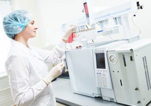 Lab Technician using a Machine